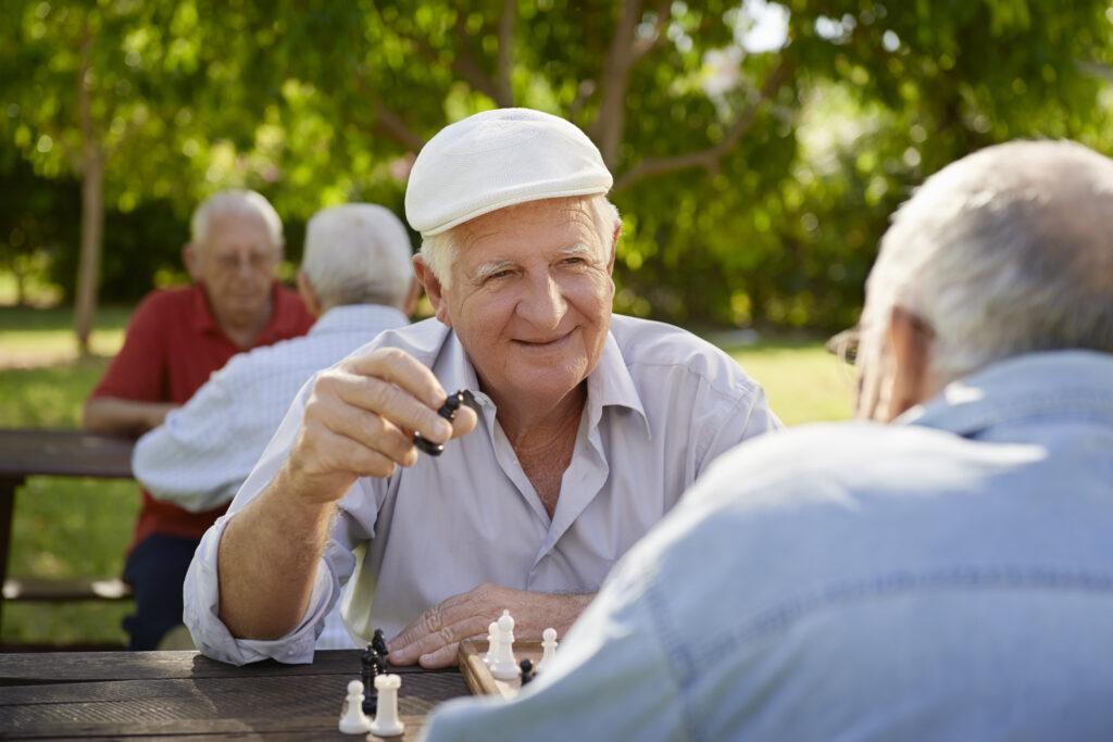 Senior men playing chess together