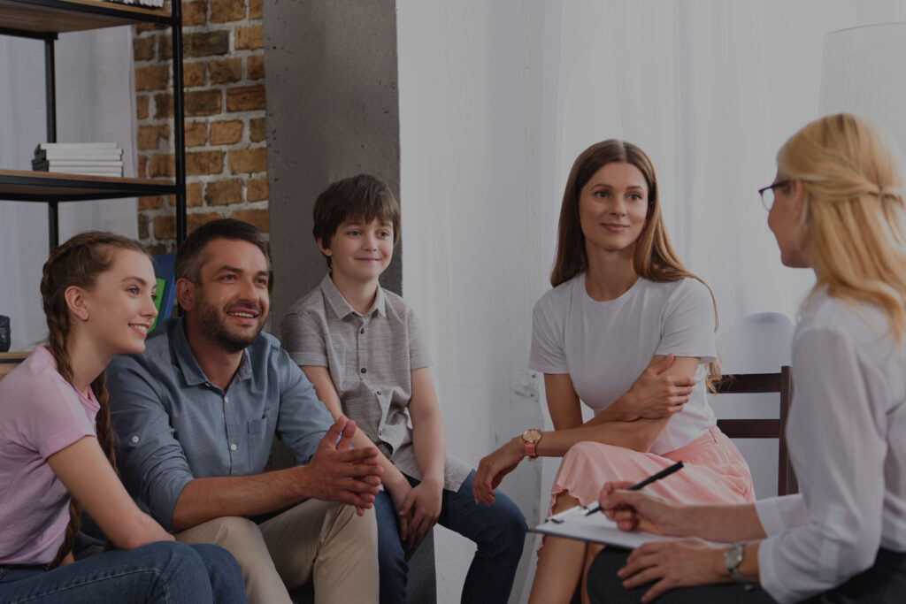 Happy family sitting together in a therapy session